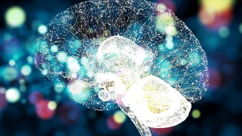 A digital illustration of a human brain with a network of glowing connections against a dark, blurry, multicolored background, evoking a sense of technology and neural connectivity.